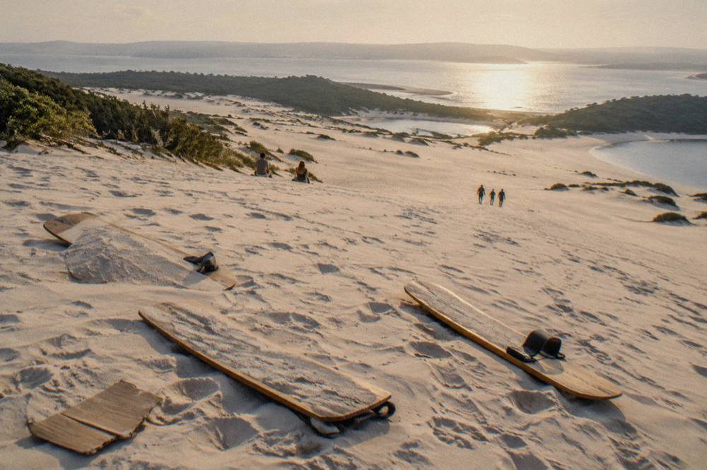 Sandboards lying on a sloping sand dune at the Stockton Bight dunes