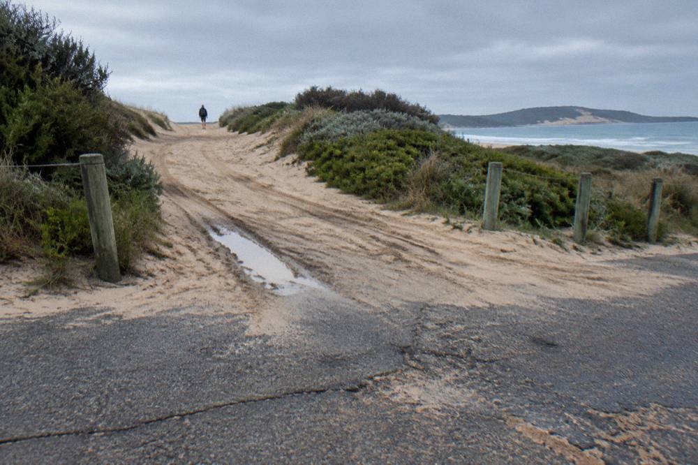 A four-wheel drive track leading from a car park onto the sand