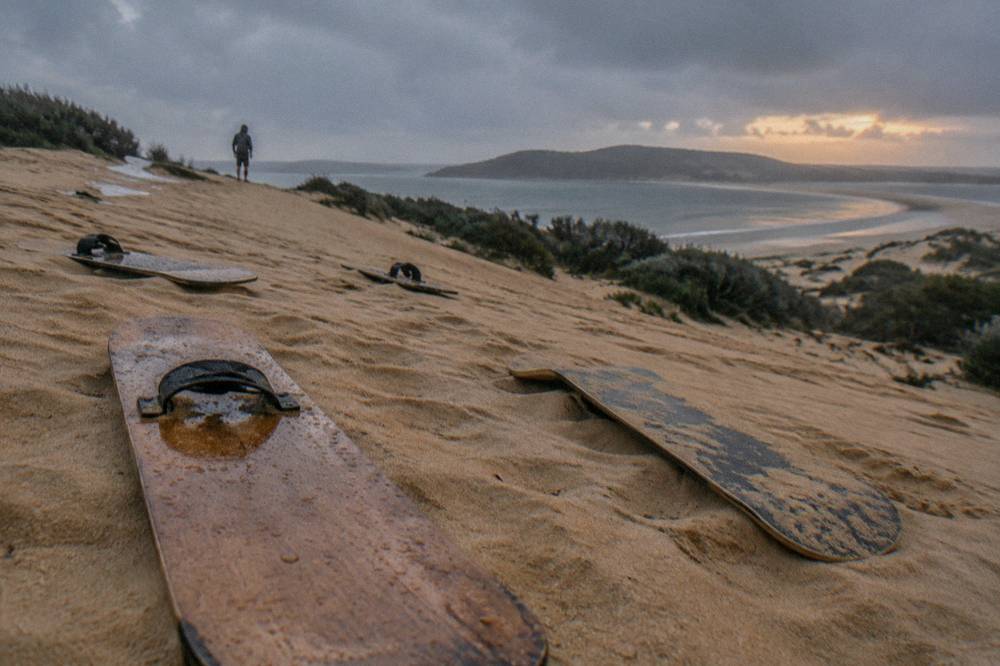 Sandboards lying on a dune slope ready for riders